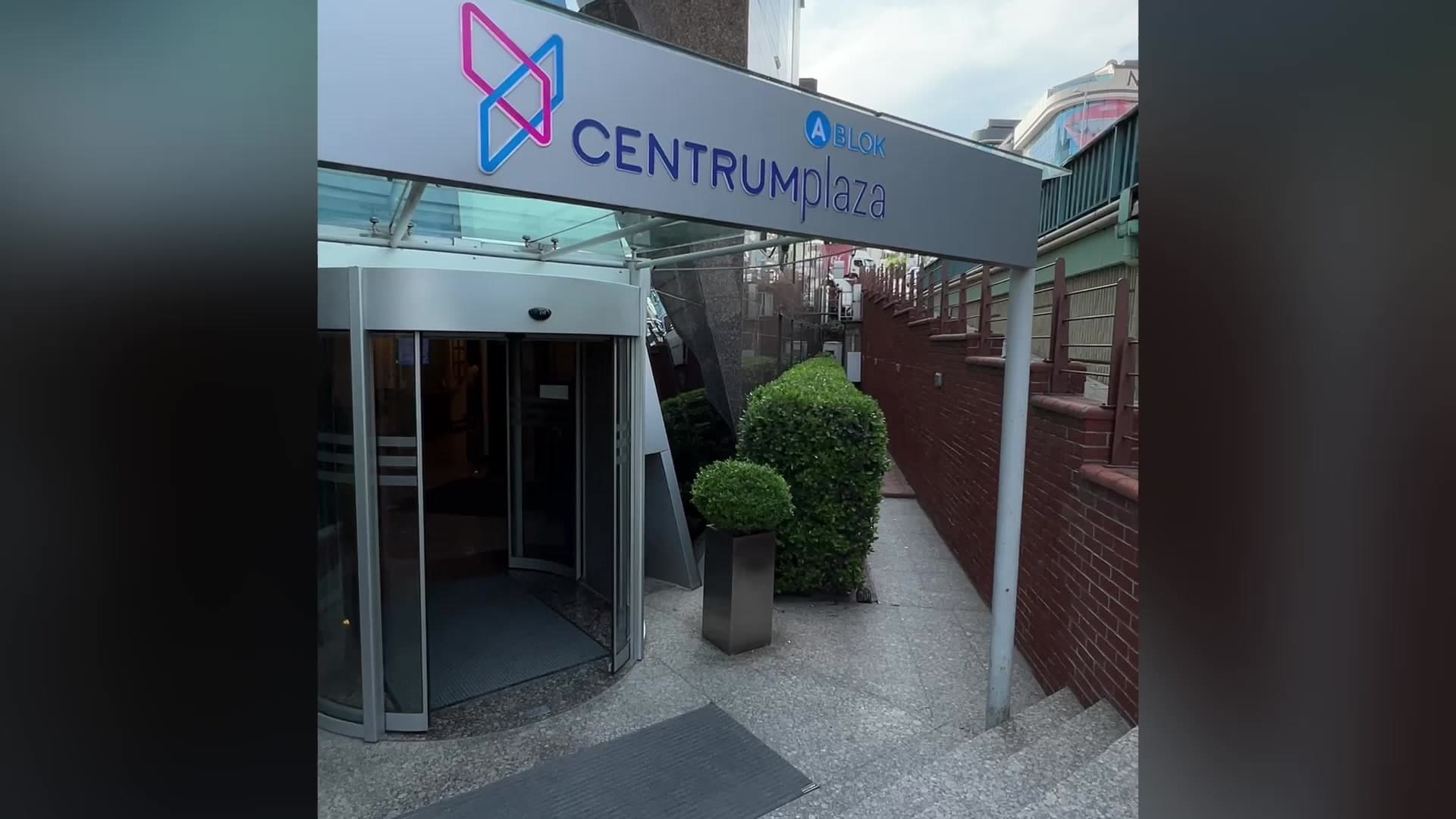 Exterior entrance of Centrum Plaza building with revolving glass door