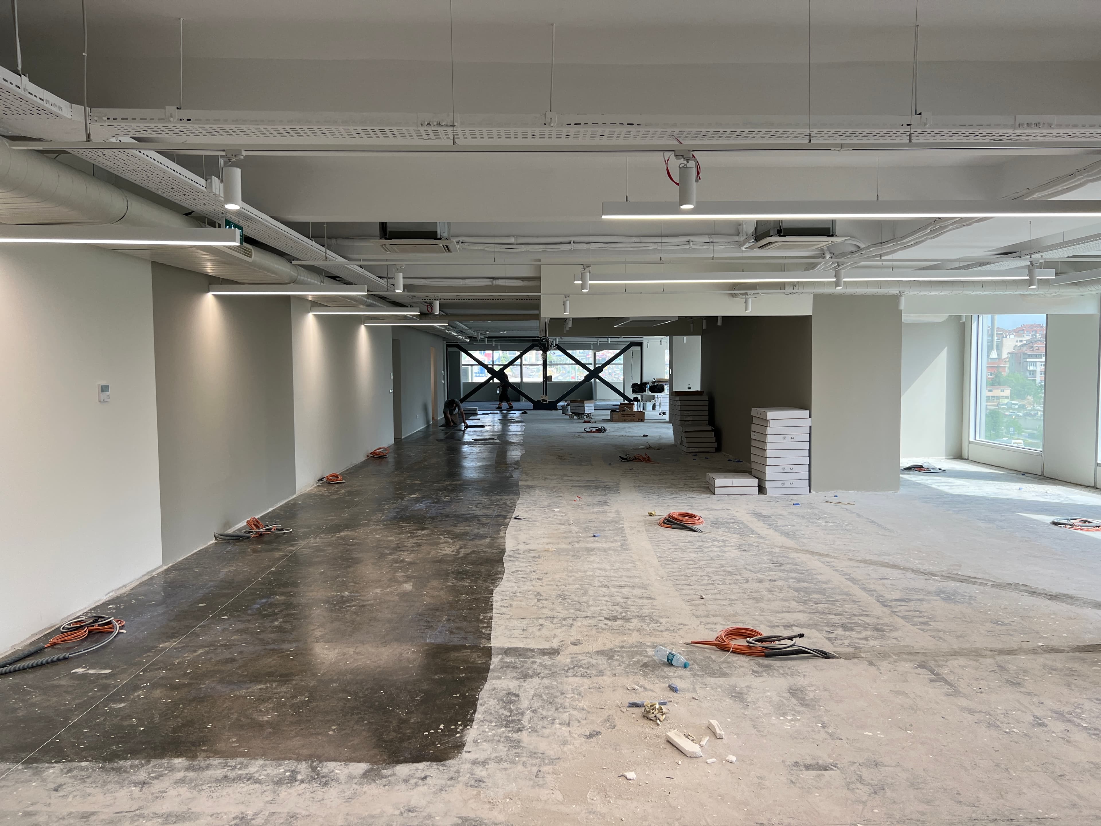 Wide construction view with steel cross-bracing and building materials on floor