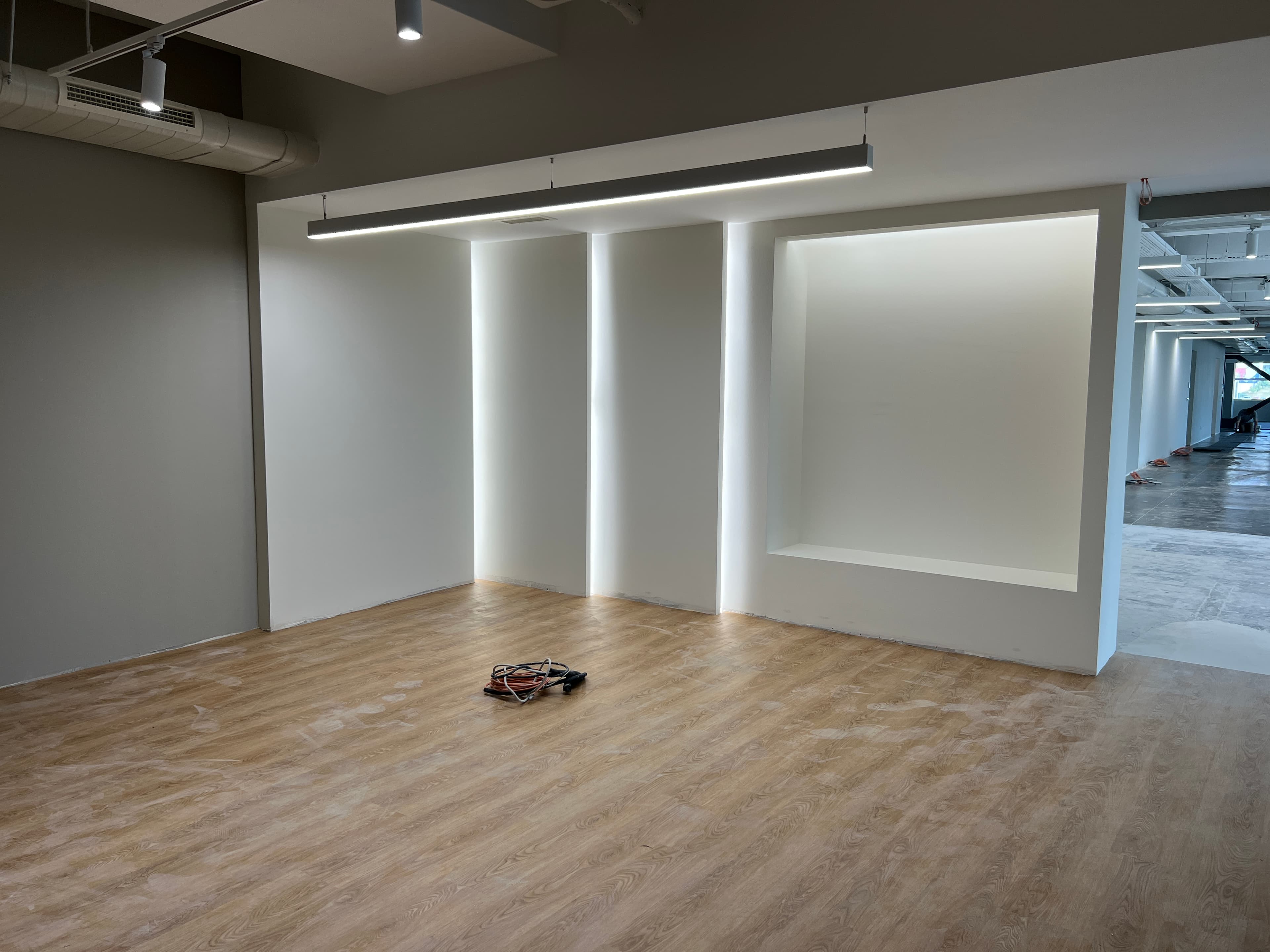 Wider angle of reception with wall niches, pendant light, and construction ongoing