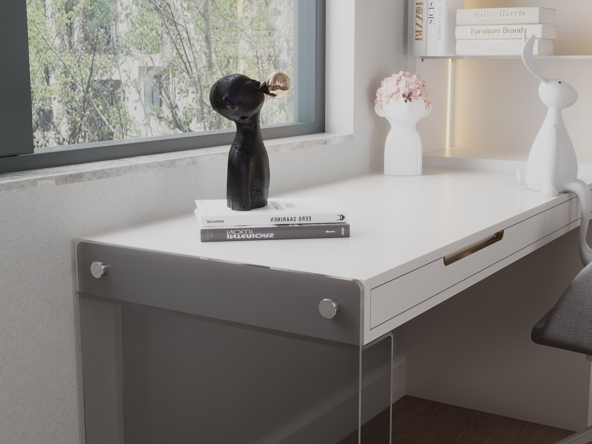 Desk detail with decorative sculpture, stacked books, and flowers