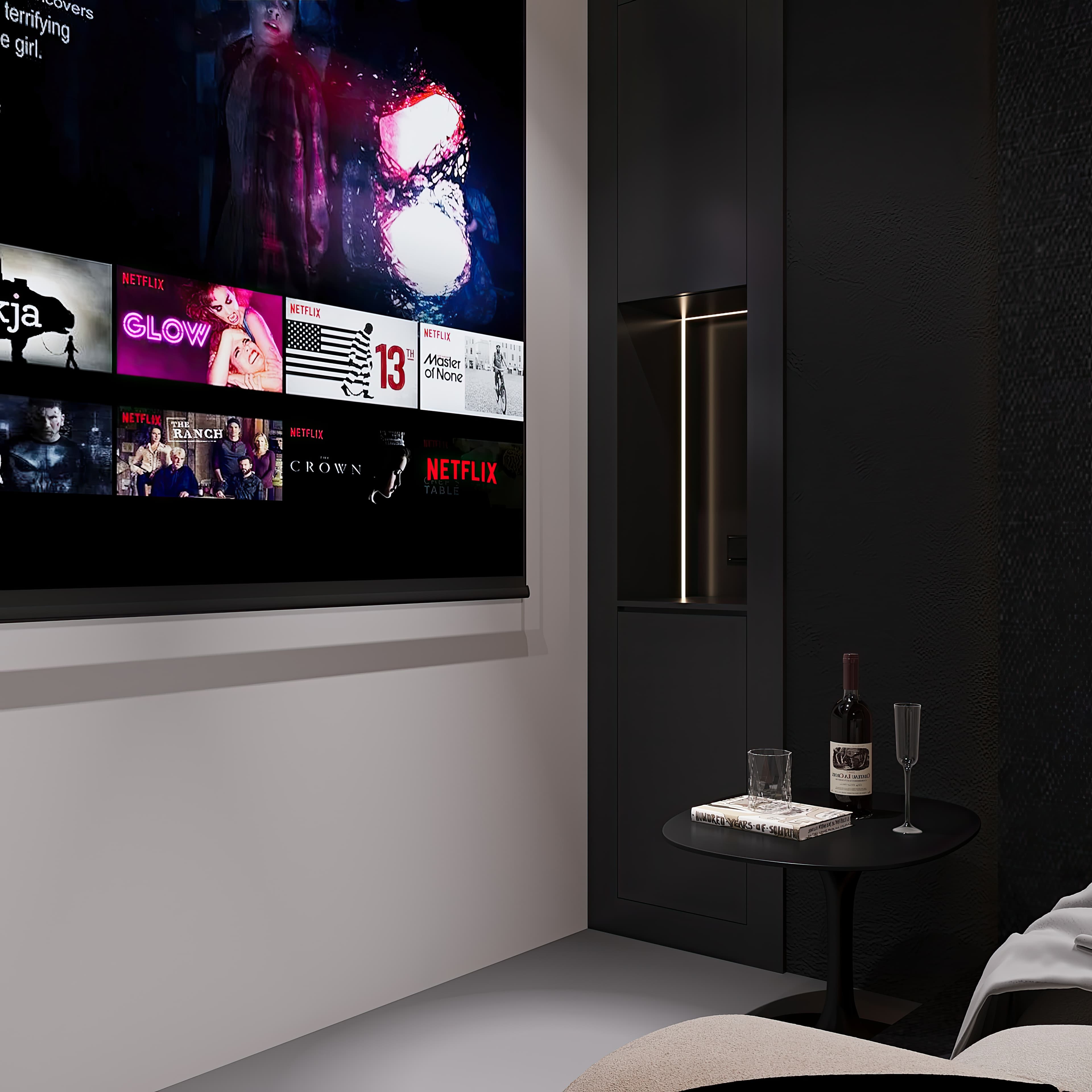 Cinema side detail with projector screen edge, wine bottle, and side table